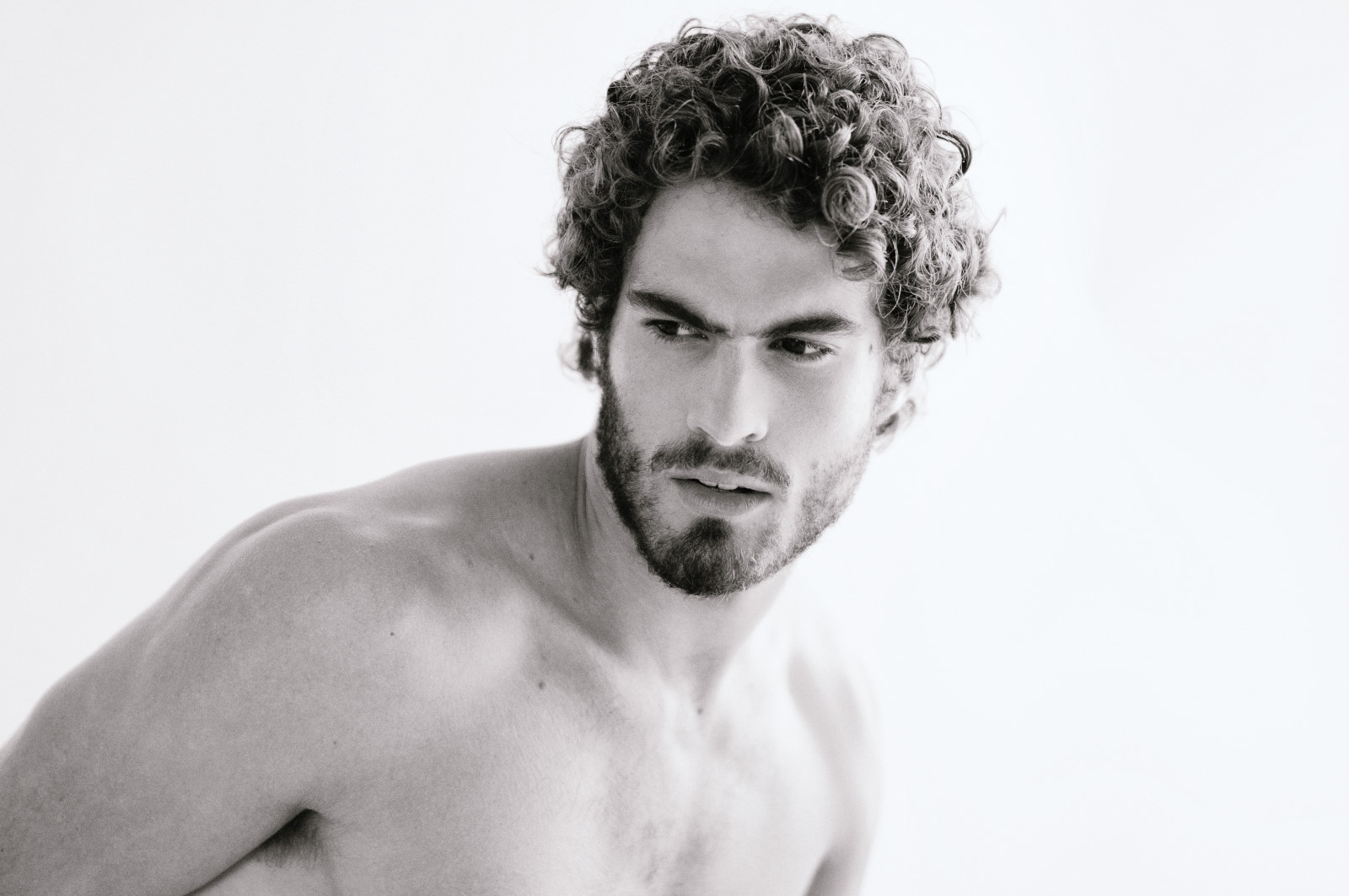 Headshot of male model, black and white studio portrait by Kent Johnson for a mens jeans label.