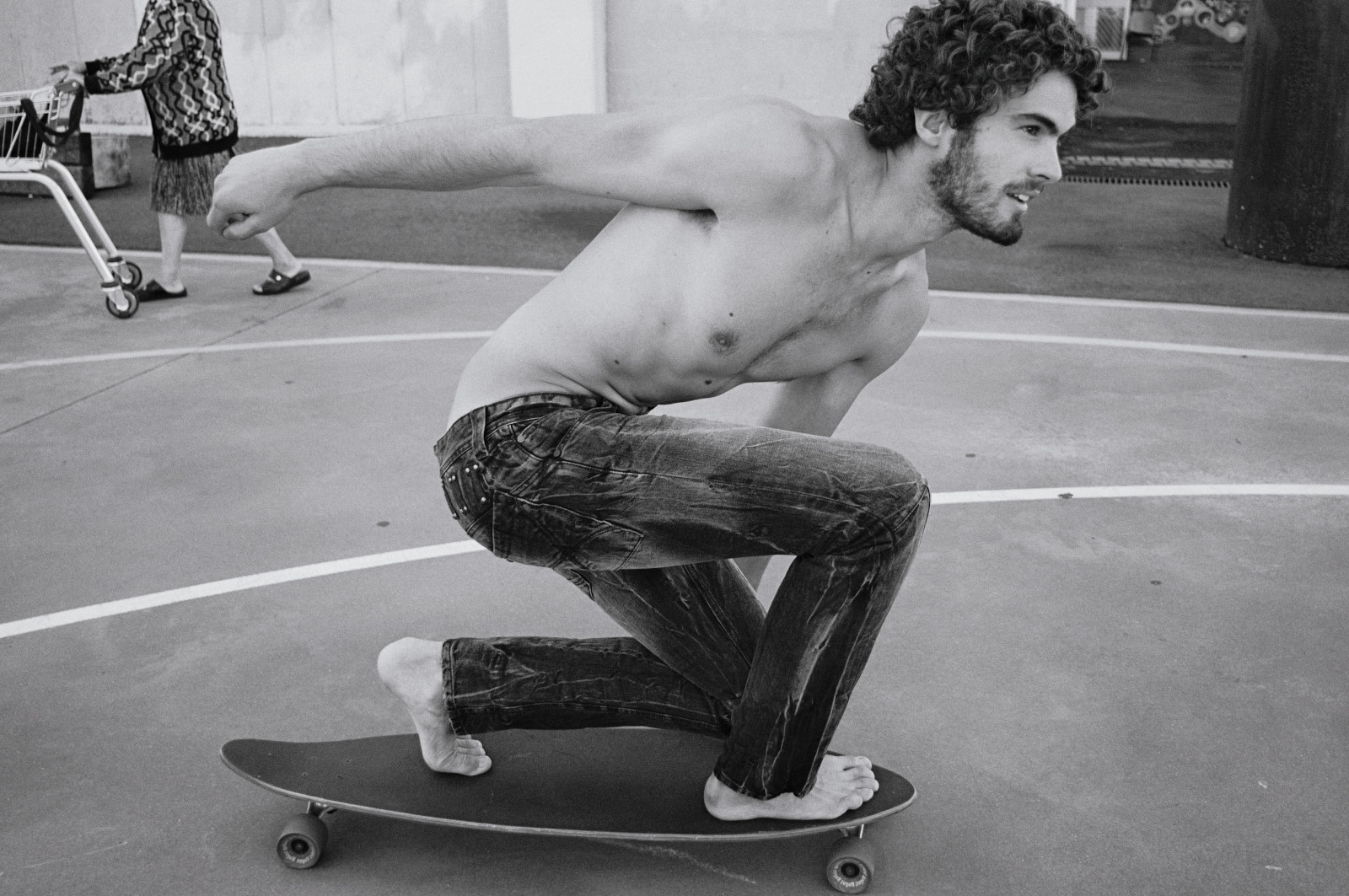 Skatboarding in distressed black denim jeans for a menswear fashion campaign, Kent Johnson Sydney, Australia