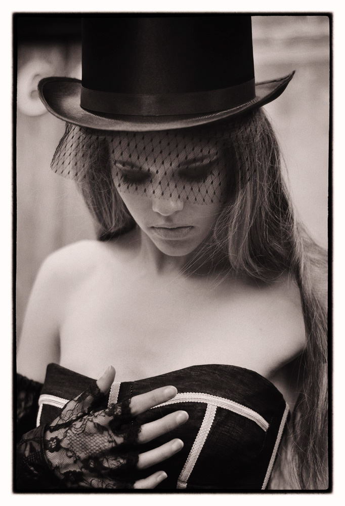 Hero B&W Headshot of Victoria in top hat with black lace veil for a fashion campaign - photographed on location by Kent Johnson, Sydney, Australia.