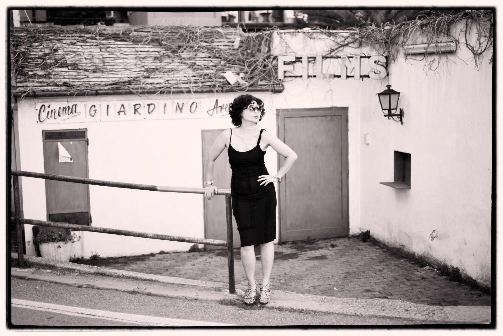 Old cinema, black dress Monterosso Italy, Fashion Photography by Kent Johnson