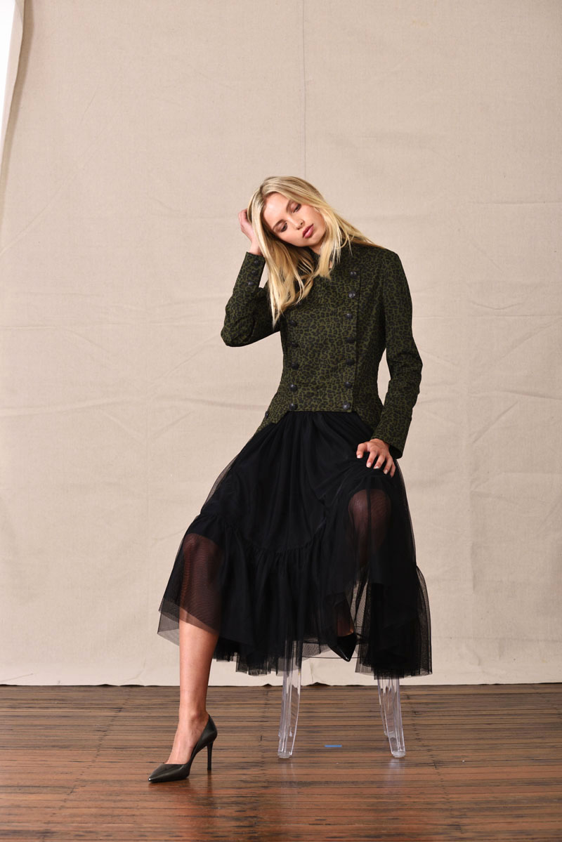 Tulle skirt and millitary jacket, seated model - eCommerce Studio Fashion Photography by Kent Johnson. Fashion marketing campaign, model on canvas background.