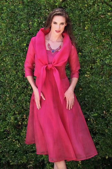 A beautiful silk dress and matching jacket in fuschia. Wedding & Race Day to Smart Fashion photographed in a beautiful garden by Kent Johnson.
