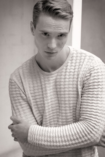Leo, black and white mid shot wearing a white jumper. Male modelling portfolio shoot, Sydney, Australia.