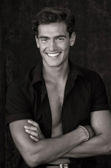 Casual menswear, open shirt fashion portrait, smiling, shot in the studio. Photographed by Kent Johnson.
