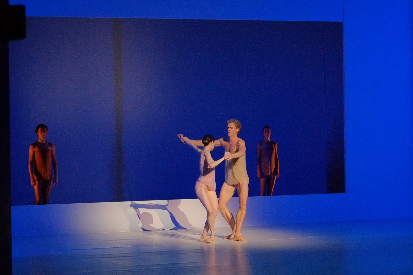 Deep blue set, two dancers, two sentinels. The Australian Ballet - CHROMA - Chorographer Wayne McGregor Photography by Kent Johnson.