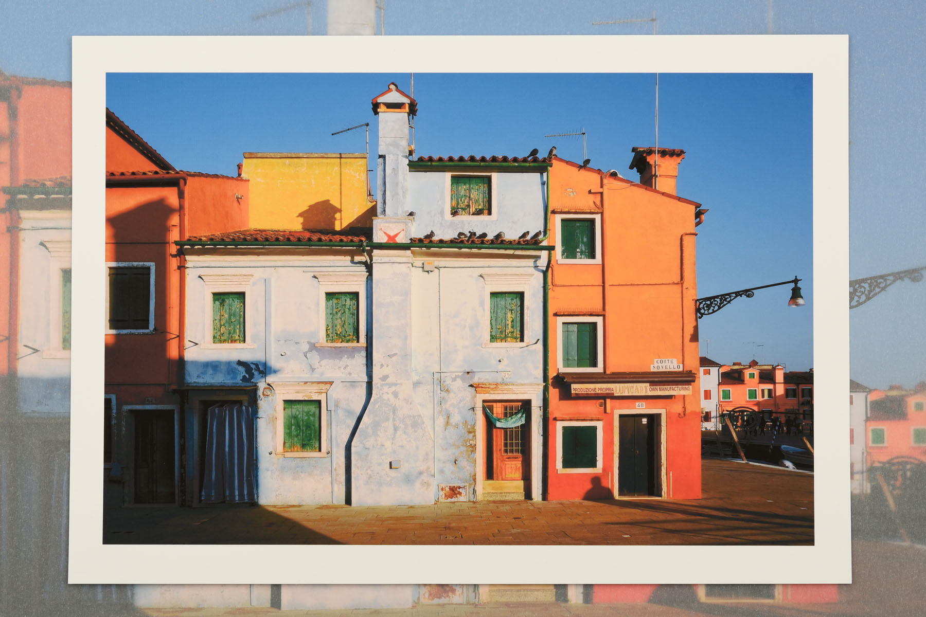 The colours of Burano. La Serenissima an exhibition of photographs and fine art prints by Kent Johnson The colourful houses of Burano in early moning light. La Serenissima an exhibition of photographs and fine art prints by Kent Johnson