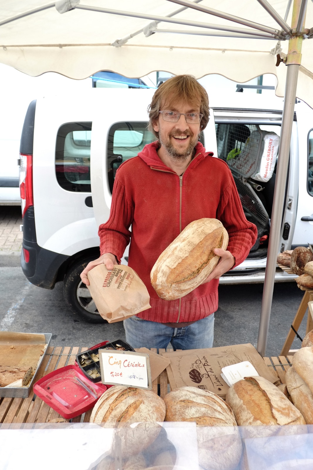 Portrait of our artisanal bread vendor, market day in Le Bois-d'Oingt. Food and travel lifestyle photography by Kent Johnson.