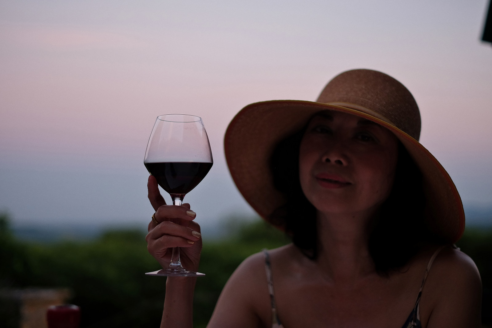 Relaxing with a glass of red wine and enjoying the sunset, Bagnols, France. Lifestyle photography by Kent Johnson.