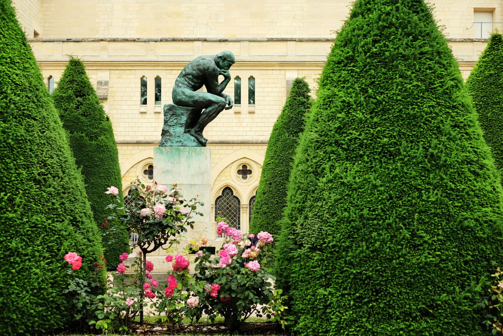 'The Thinker' sculpture, gardens and shrubbery, Musée Rodin, Paris, France. Travel and lifestyle photography by Kent Johnson.