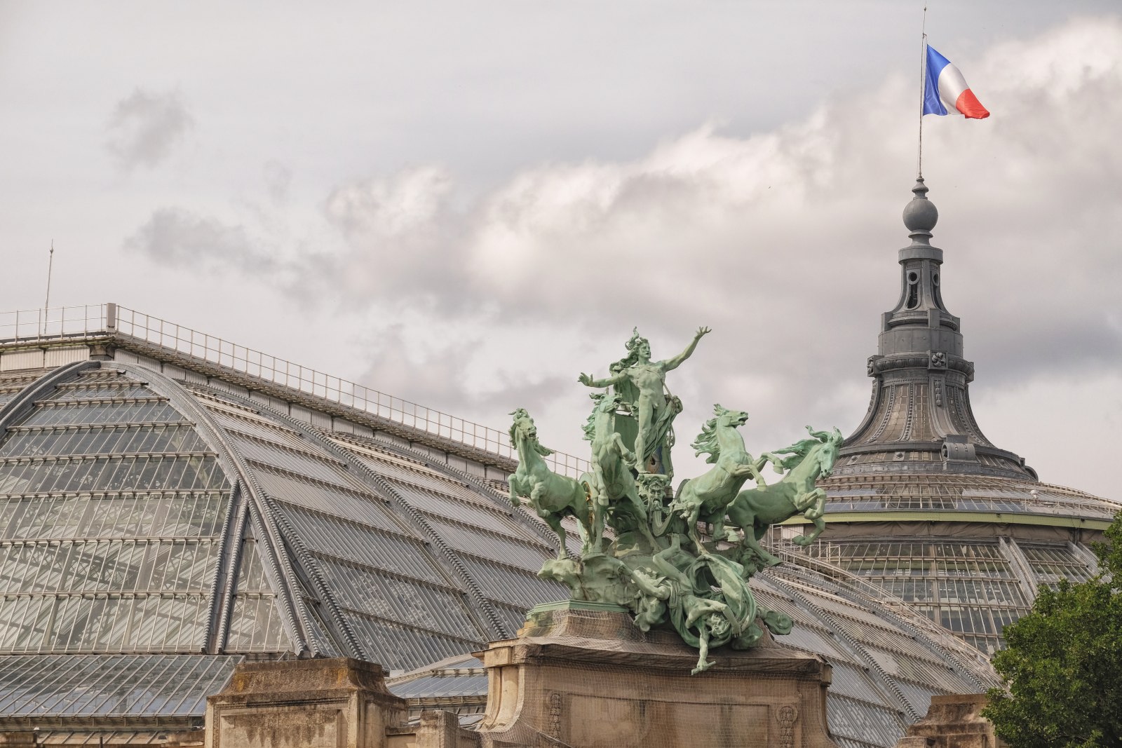 Grand Palais, glass roof and sculpture; L'Harmonie triomphant de la Discorde (1900) by Georges Récipon. Travel and architecture photography by Kent Johnson.