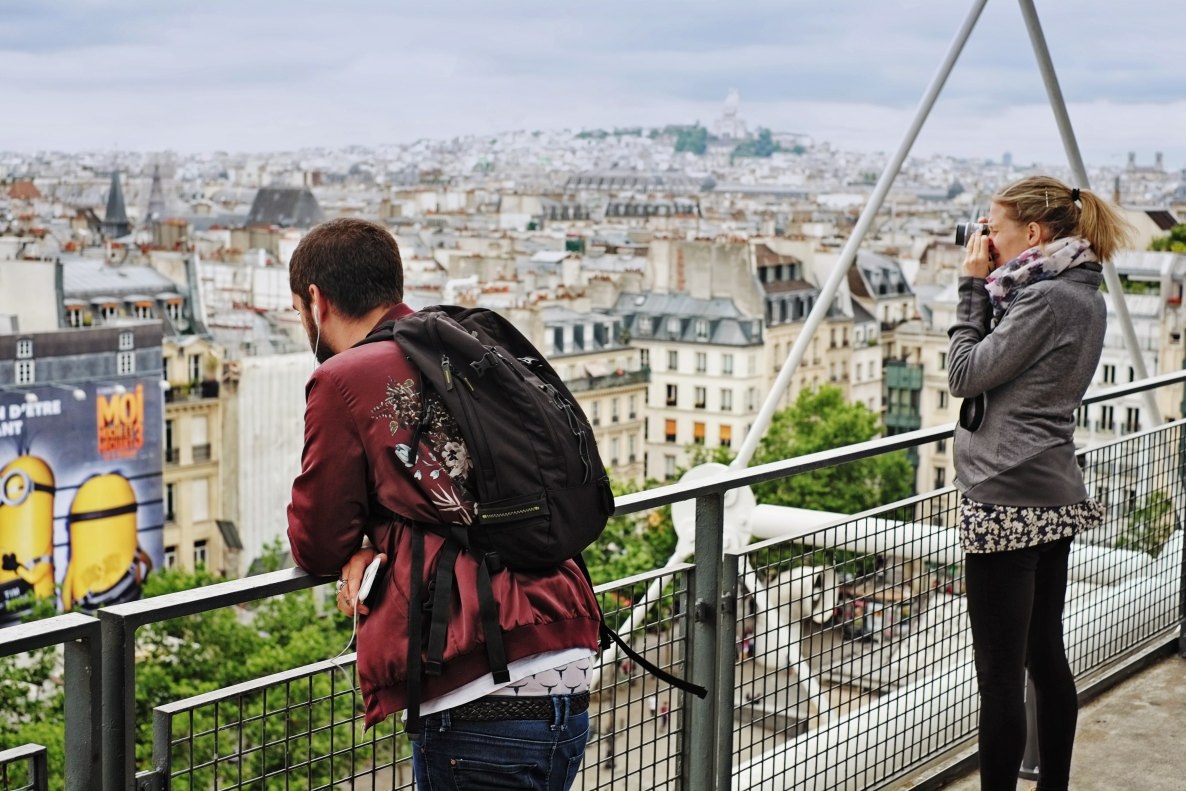 Travellers photograph Paris from the rooftop level of the Centre Pompidou