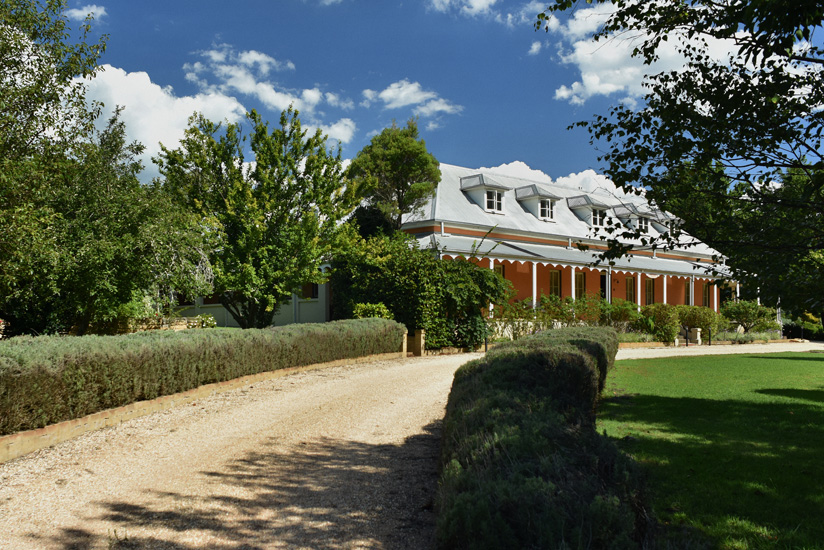 Australian lifestyle photography. The historic Fitzroy Inn Mittagong, Southern Highlands; seen from the long gravel drive and surrounging gardens. Travel and garden photography by Kent Johnson.