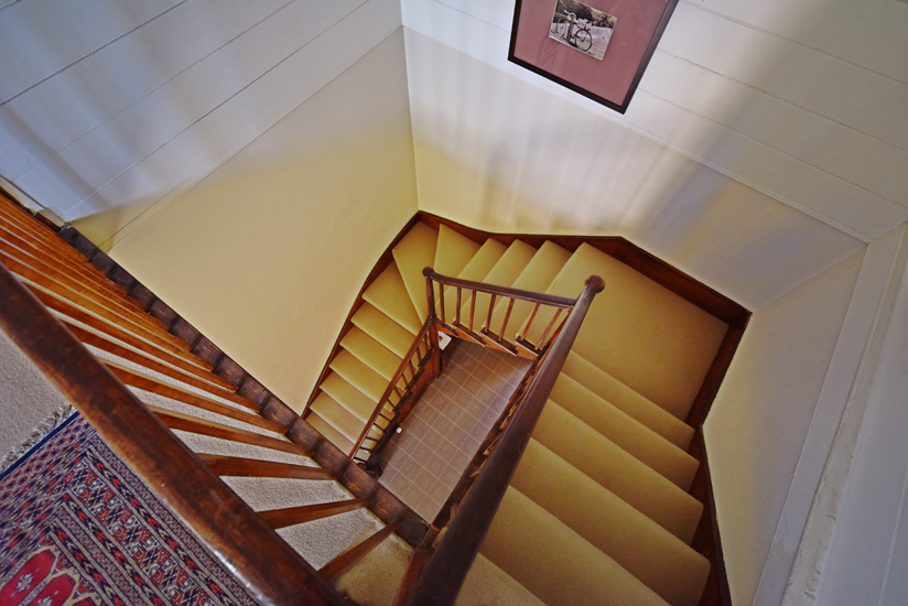 Timber staircase to the upper level of the Fitzroy Inn. Hotel interior and travel photography by Kent Johnson.