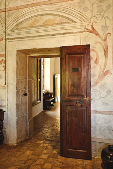 A view through the main room doorway into the Château hallway with masonary details. Hotel photography by Kent Johnson.