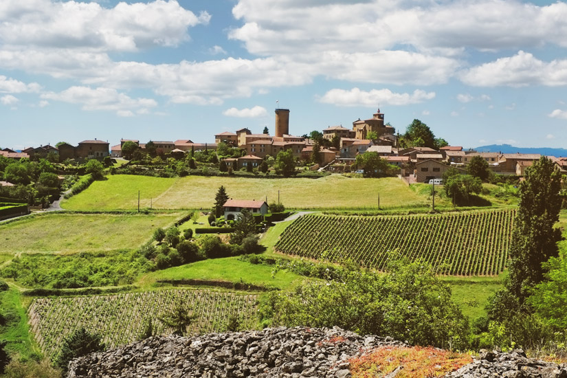 A view across the valley to the medieval village of Oingt from Route de Moiré. Travel photography by Kent Johnson.