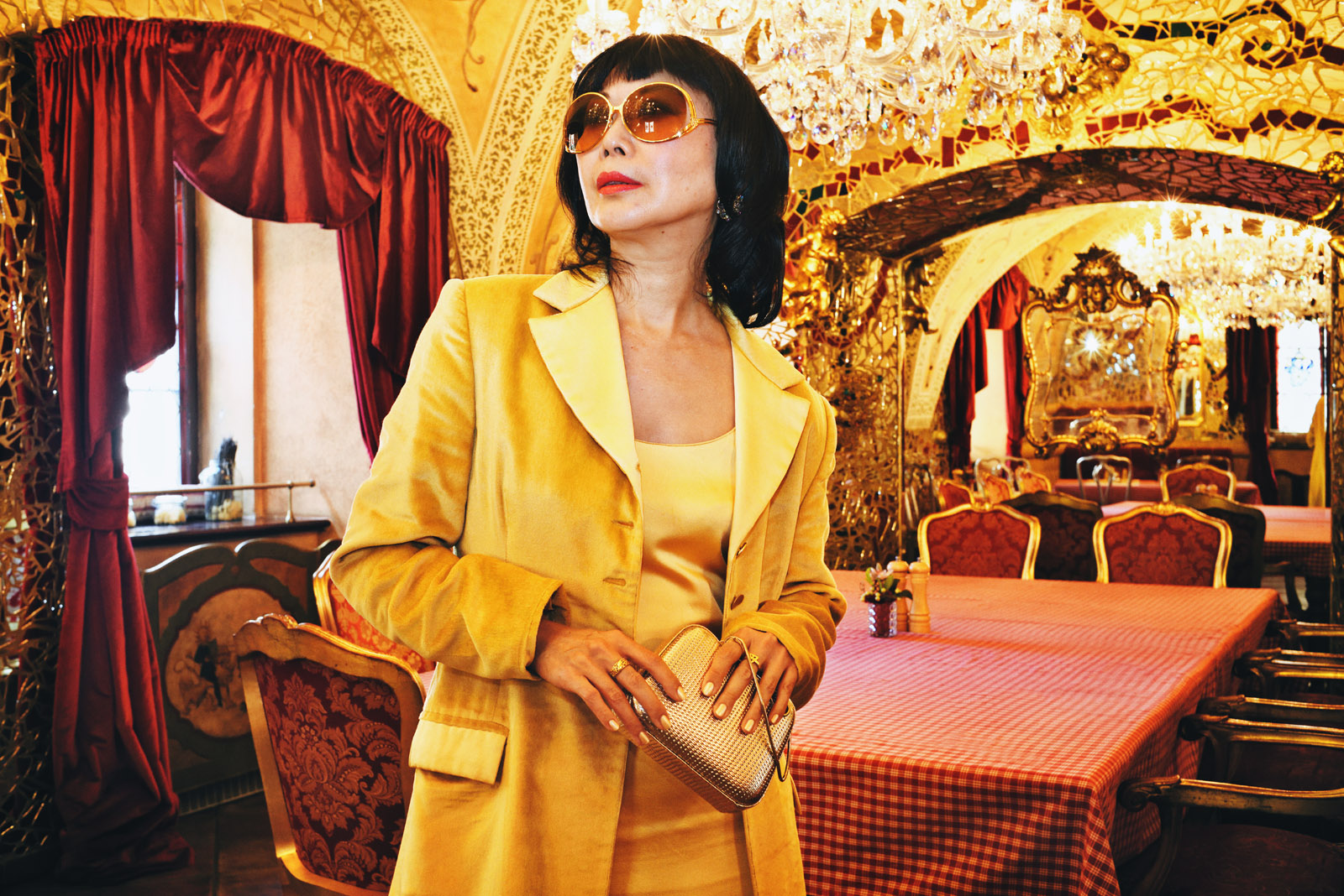 Mirrored restaurant in Prague, Vivienne with gold clutch, fashion photography by Kent Johnson