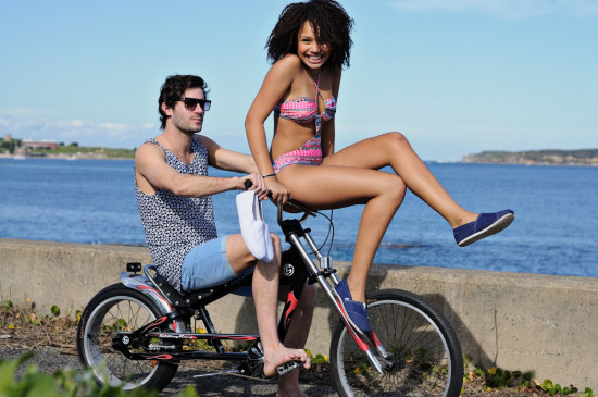 Shoe campaign, guy with girl in swimwear sitting on bicycle handlebars. Sydney, Australia.