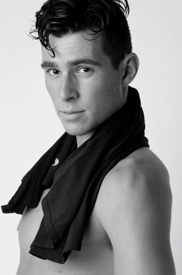 Black and white studio headshot for a male modelling portfolio.