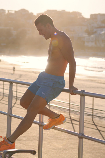 Morning on Bondi beach for a male model portfolio shoot, shorts and runners, fitness and health.