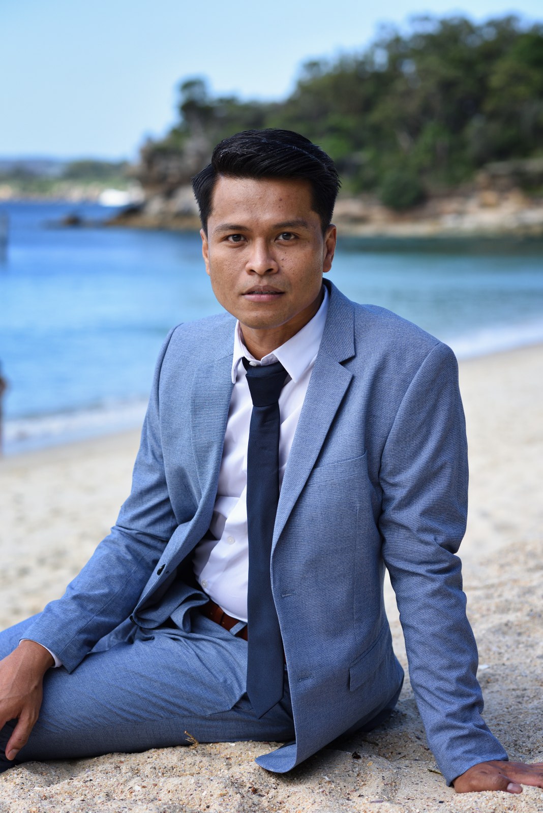 An alternative approach to a business portrait, a suit and sand, harbourside at Nielsen Park, Sydney. Photographed by Kent Johnson.