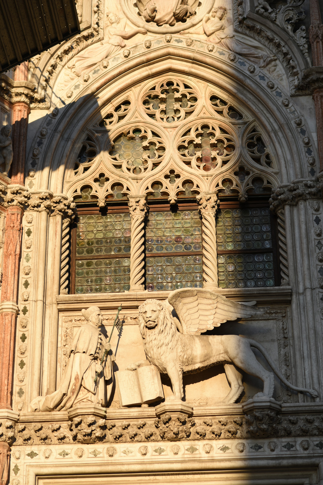 Entrance to Doges Palace, Winged lion, Doge, murano glass window, San Marco Venice. Travel and architectural photography by Kent Johnson.